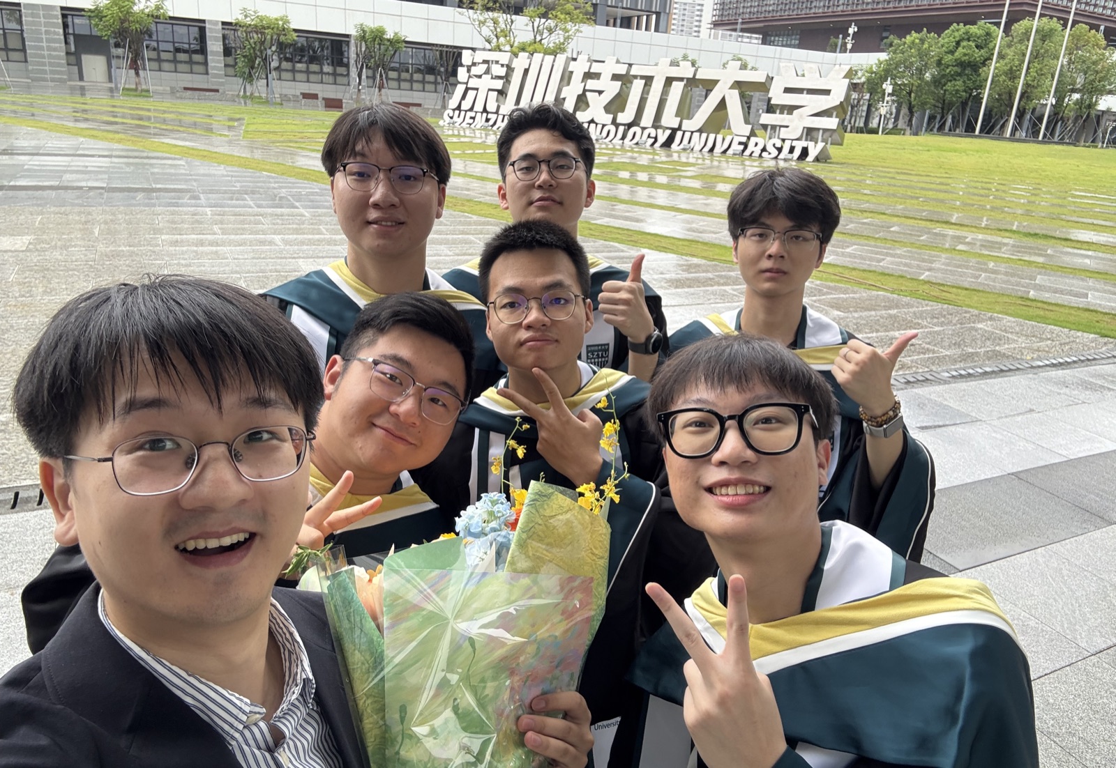 Group members celebrating graduation at Shenzhen Technology University